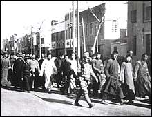 Chinese prisoners of war being led by Japanese troops.